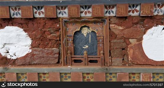 Close-up of Buddha sculpture on a wall at Dochula Pass, Thimphu, Bhutan