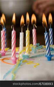 Close-up of burning candles on a birthday cake