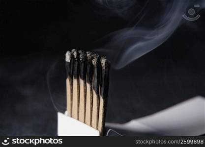 Close-up of burnt matchsticks in a matchbox