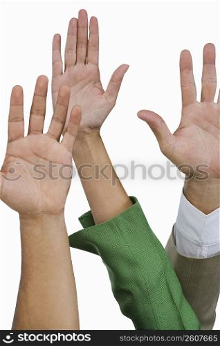 Close-up of business executives raising their hands