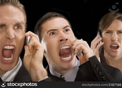 Close-up of business executives shouting on a mobile phone