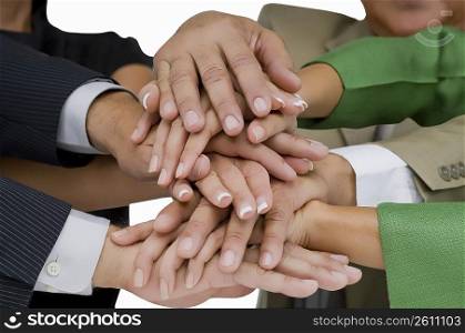 Close-up of business executives stacking hands