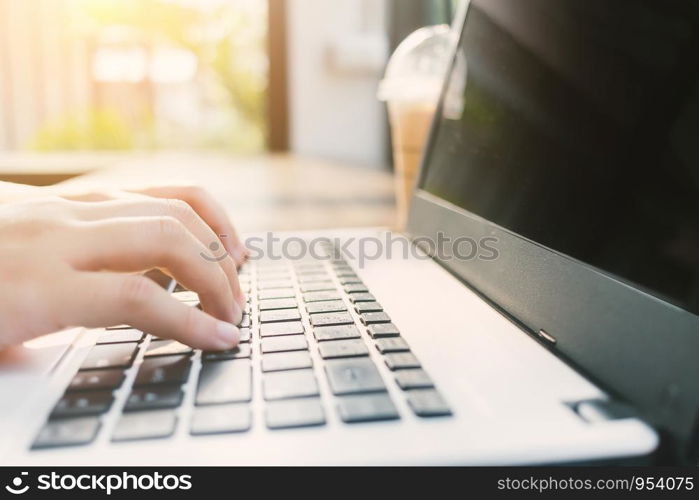 Close-up of Business female working with laptop coffee in coffee shop like the background.