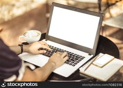 Close-up of business female working with laptop ,smartphone,notebook in coffee shop like the background.