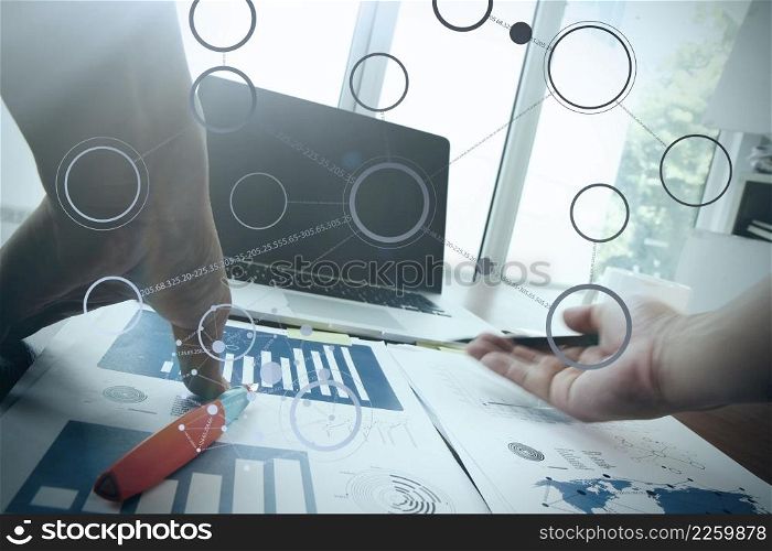 Close up of business man hand working on blank screen laptop computer on wooden desk as concept with social media diagram
