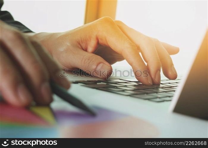 close up of business man hand working on blank screen laptop computer on wooden desk as concept