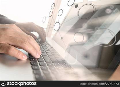 Close up of business man hand working on laptop computer with social media diagram and chart graph on wooden desk as concept
