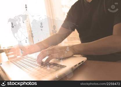 Close up of business man hand working on laptop computer with social media diagram and chart graph on wooden desk as concept