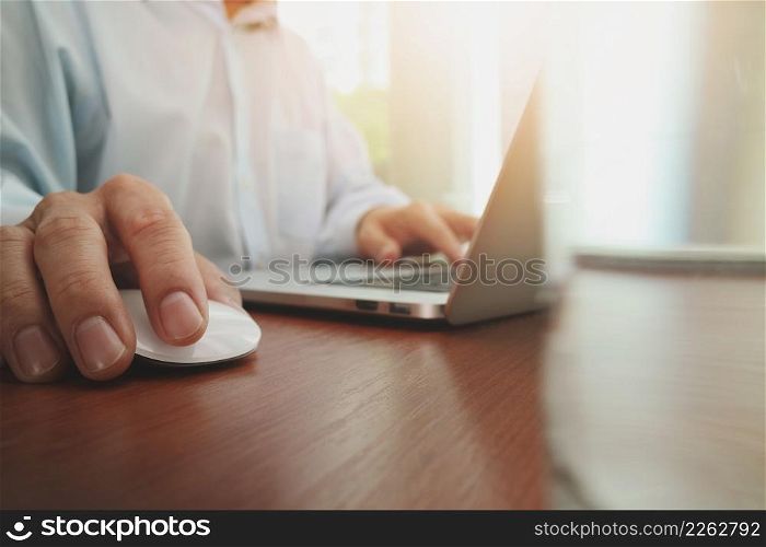 close up of business man hand working on laptop computer with social media diagram on wooden desk