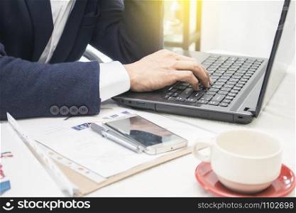 Close up of business man hands typing on laptop computer