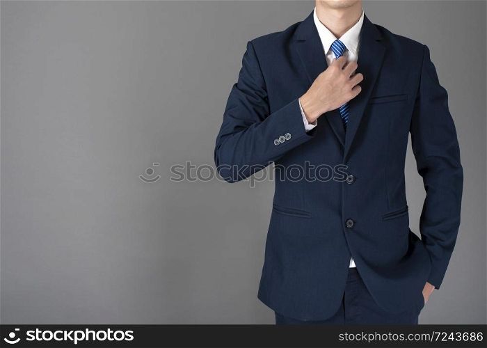 close up of business man in blue suit is confident on gray background