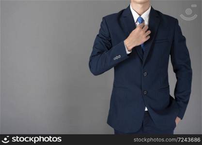 close up of business man in blue suit is confident on gray background
