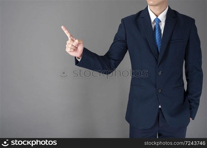 close up of business man in blue suit is pointing something on gray background