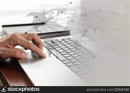 Close up of business man working on laptop computer with social network diagram on wooden desk as concept