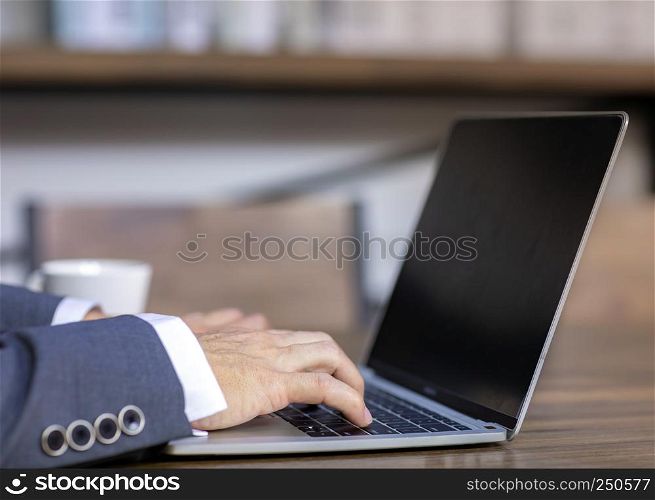 close up of business man working with laptop