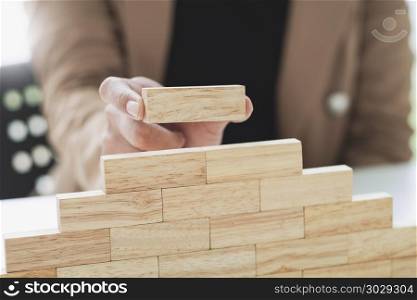 close up of business people holding wooden block, risk and strategy concept. close up of business people holding wooden block, risk and strat