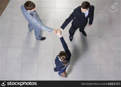 Close up of business peoples hands on top of each other. Together we can do it