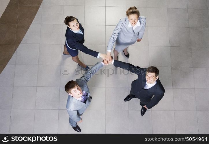 Close up of business peoples hands on top of each other. Together we can do it