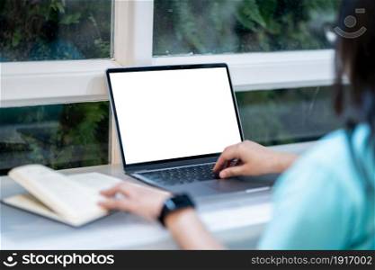 Close-up of businessfemale wearing smartwatch casual working with laptop computer with empty white screen and book with coffee cup and smartphone in at the cafe, Business Lifestyle communication
