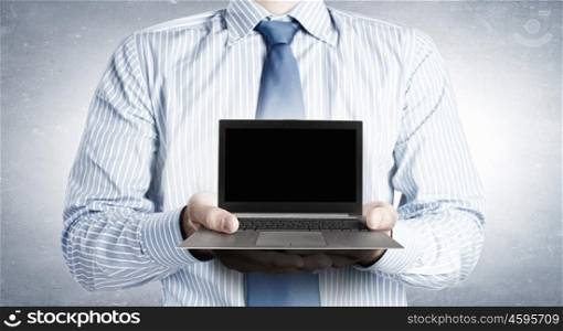 Close up of businessman&amp;#39;s hands holding laptop