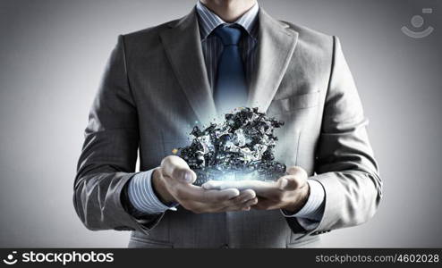 Close up of businessman&amp;#39;s hands holding many laptops