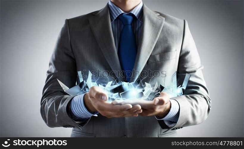 Close up of businessman&amp;#39;s hands holding many laptops