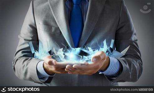 Close up of businessman&amp;#39;s hands holding many laptops
