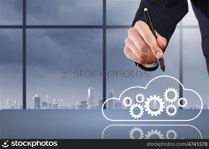 Close up of businessman hand drawing cloud computing concept. Network business