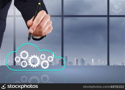 Close up of businessman hand drawing cloud computing concept. Network business