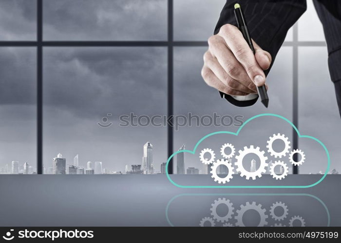 Close up of businessman hand drawing cloud computing concept. Network business