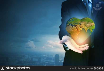 Close up of businessman hand holding Earth planet. Elements of this image are furnished by NASA. Love your planet