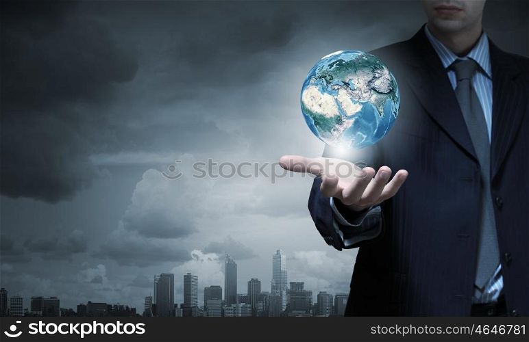 Close up of businessman hand holding Earth planet. Elements of this image are furnished by NASA. Love your planet