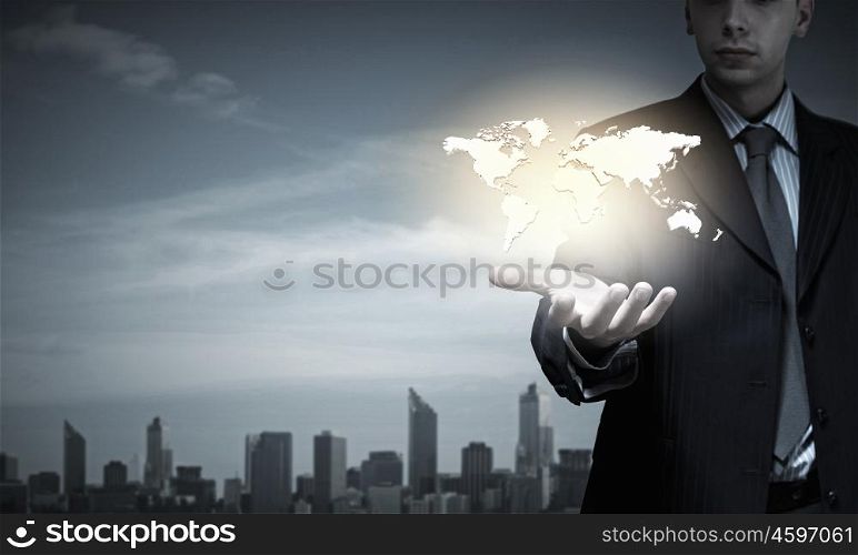 Close up of businessman hand presenting world map. Rule the world