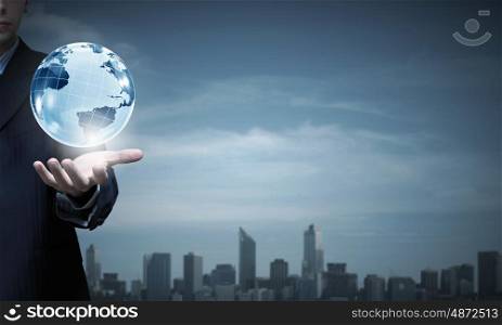 Close up of businessman hand showing digital earth globe. Business and future technology concept