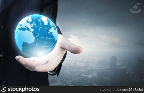 Close up of businessman hand showing digital earth globe. Business and future technology concept