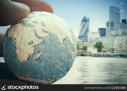 close up of businessman hand showing texture the world-Elements of this image furnished by NASA london city background