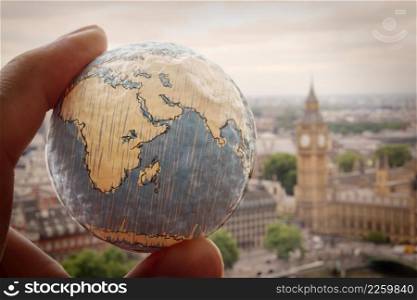 close up of businessman hand showing texture the world with london city background Elements of this image furnished by NASA