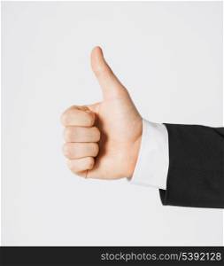 close up of businessman hand showing thumbs up