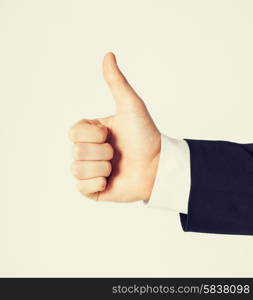 close up of businessman hand showing thumbs up