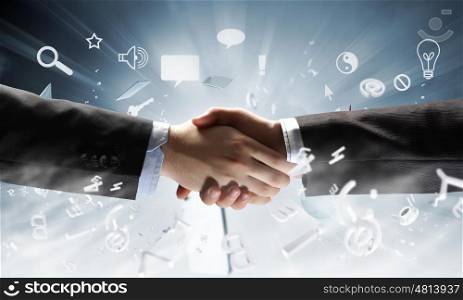 Close up of businessman hands making deal. Business handshake