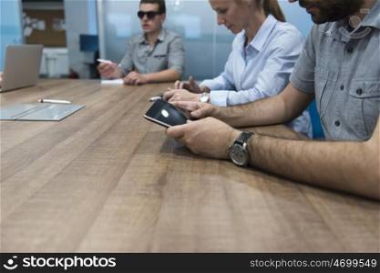 close up of businessman hands using tablet people group in office meeting room blurred in backgronud