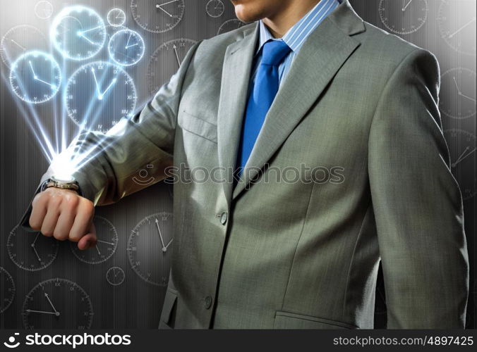 Close up of businessman looking at watch at his wrist