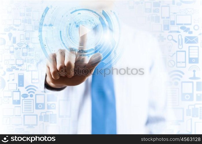 Close up of businessman pressing virtual icon on screen. Man pushing icon