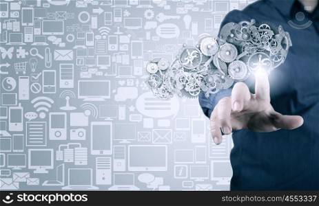 Close up of businessman pushing gear icon on media screen. Businessman activating gears mechanism