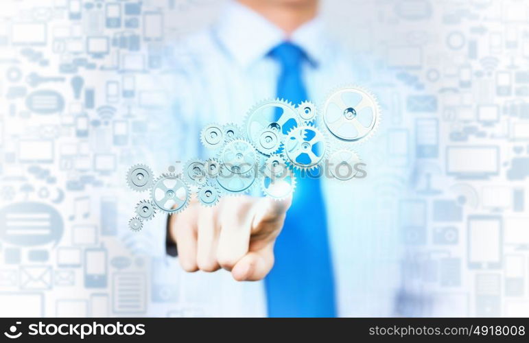 Close up of businessman pushing gear icon on media screen. Businessman activating gears mechanism