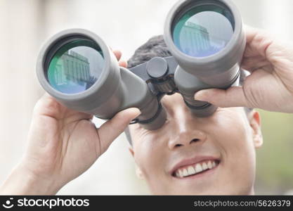 Close Up of Businessman Using Binoculars, Reflection