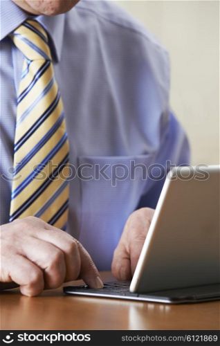 Close Up Of Businessman Using Digital Tablet With Detachable Keyboard