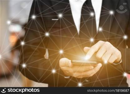 Close up of Businessman using smartphone with icon network. Man hand holding mobile phone for technology or internet banking concept.