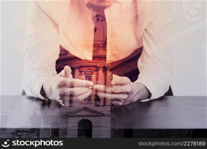 close up of businessman working with mobile phone on wooden desk in modern office with virtual icon diagram with London city exposure
