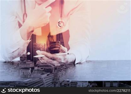 close up of businessman working with smart phone on wooden desk in modern office with London city exposure
